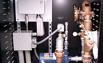 A backflow prevention and valve assembly mounted on a wall