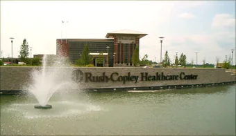 A fountain running in a pond at the entrance to a healthcare campus