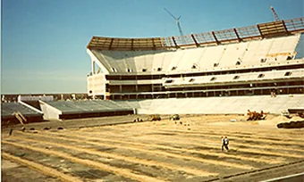 A stadium under construction with the field graded to subgrade